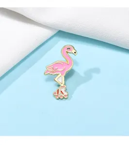 Detail view of the cute pink flamingo enamel pin with roller skates design on fabric.