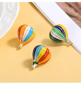 Detailed shot of colorful hot air balloon enamel brooch pins, showing exquisite details.