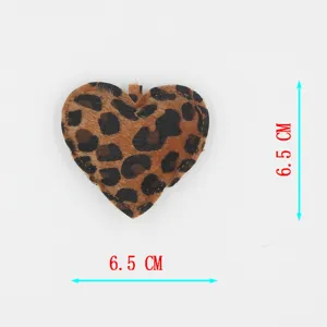 Detail shot of the cute leopard print heart keychain pendant, showing fuzzy plush texture and size.