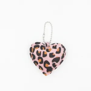 Pink leopard print heart keychain detail view, cute plush bag pendant with metal ball chain.