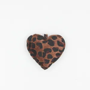 Leopard print plush heart keychain pendant close-up, fluffy texture bag charm accessory.