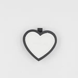 Heart-shaped leather keychain bag charm black white layered pendant accessory details view