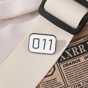Detail shot of the creative number 011 enamel brooch, alloy badge for stylish backpack decor.