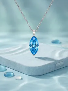 Close-up of sparkling marquise blue crystal pendant necklace showcasing clear silver chain detail.