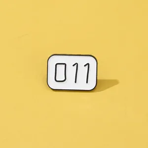 Close up detail shot of the creative number 011 enamel lapel pin accessory show.