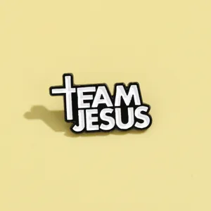 Black and white enamel pin featuring the inspirational message TEAM JESUS with a cross.