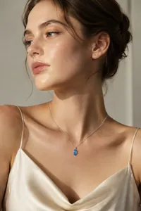 Stunning marquise blue gemstone pendant close-up, delicate sterling silver clavicle chain details.