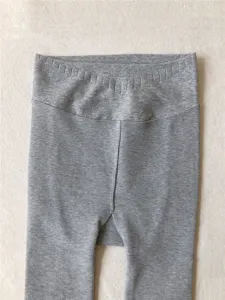Close-up view of grey ribbed high-waisted V-cut leggings showing soft knit texture details.
