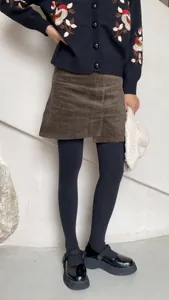 Detail shot of thermal winter tights paired with chic skirt, soft and warm daily wear style.