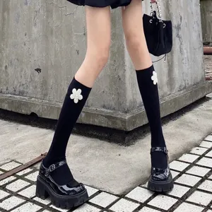 Black calf socks featuring elegant white pearl flower decoration for stylish daily wear outfits.