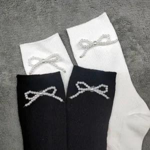 Cotton mid-tube calf socks featuring elegant pearl bow design in black and white colors.