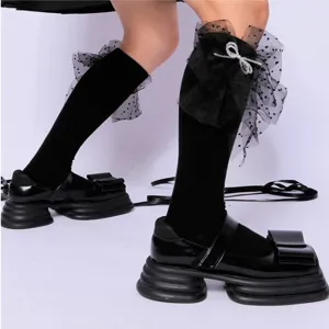 Black mesh bow ruffle knee high socks with crystal details cute Lolita platform shoes pair.