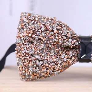 Close-up detail of sparkling rhinestone bow tie with crystal center, elegant formal accessory.