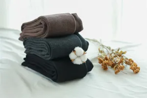 Detailed view of thick winter vertical striped tights in three classic colors, soft and warm.