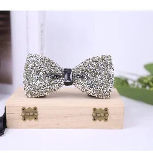 Detailed view of the sparkling rhinestone bow tie with a dark central crystal gem.