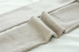 Close-up detail of thick fleece-lined ribbed thermal leggings in cozy oatmeal beige color.