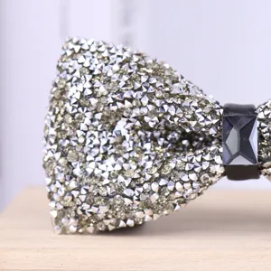 Sparkling rhinestone bow tie close-up showing intricate crystal texture and design details.