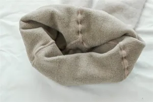 Close-up detail view of winter thick fleece-lined warm ribbed tights in oatmeal beige.