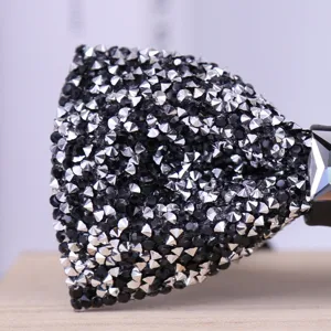 Detail shot of a sparkling rhinestone bow tie, showcasing intricate crystal and crystal texture.