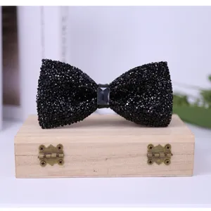 Detailed view of exquisite black rhinestone bow tie with crystal center, elegant accessory.