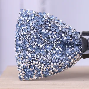 Close-up detail of a mens sparkling light blue rhinestone bow tie with silver spike studs.