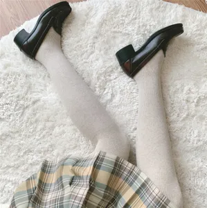 Thermal thick ribbed pantyhose detail shot featuring soft cashmere feel knit tights in oatmeal.