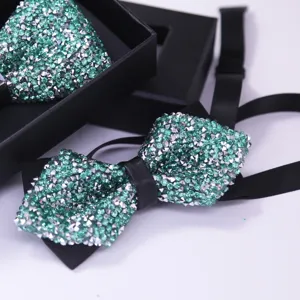 Close up view of luxury green rhinestone crystal bowtie with black strap and elegant gift box.