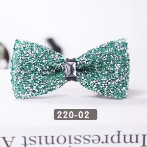 Sparkling green crystal bow tie close-up, elegant rhinestone design for wedding and formal wear.