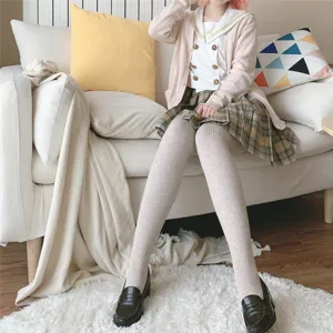 Cozy oatmeal beige vertical striped thermal tights close-up, showing soft fleece texture.