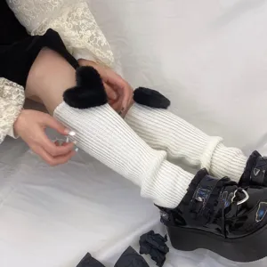 White knit leg warmers with black fluffy hearts, cute winter cozy warm boot cuffs for women.