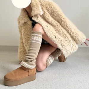 Vue détaillée de jambières épaisses en tricot avec motif flocon et bottes plateforme.