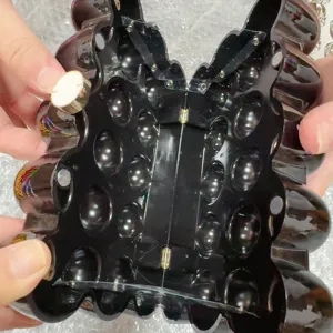 Acrylic evening clutch detail view, black hard shell box bag with metal hinge and clasp.
