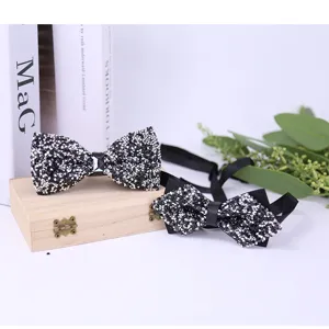 Detailed close-up view of black crystal sequin bowtie, sparkling rhinestone bow tie accessory.
