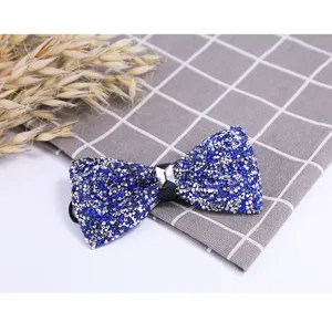 Blue crystal rhinestone bow tie detail shot showcasing sparkling gemstone craftsmanship and elegant design.