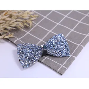Close-up detail of a sparkling blue rhinestone bow tie with center crystal accent for men.