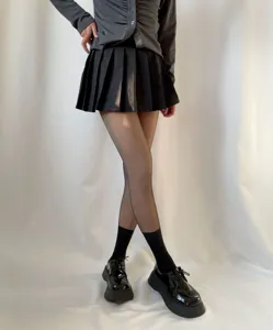 Detailed view of women autumn winter fake translucent black pantyhose slimming leg socks fashion outfit.