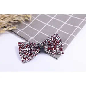 Detailed view of a sparkling burgundy crystal rhinestone bow tie, perfect for wedding groom attire.