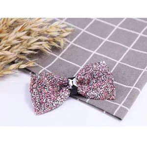 Sparkling pink crystal bow tie detail, elegant rhinestone wedding groom shirt accessory close up