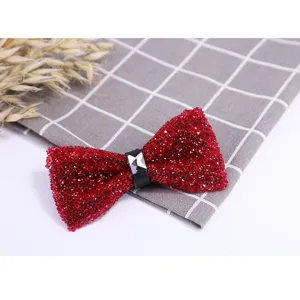 Burgundy crystal bow tie detail, sparkling rhinestone center, elegant formal wedding accessory.