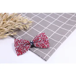 Red rhinestone bow tie detail shot, sparkling crystal groomsmen wedding formal neckwear.