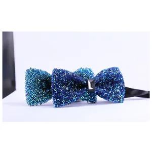 Detailed close-up of a sparkling dark blue 3D crystal rhinestone bow tie for men's formal wear.