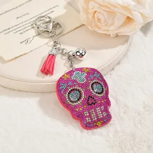 Crystal rhinestone skull keychain with pink tassel, stylish bag charm and gift for Halloween.