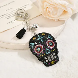 Rhinestone skull keychain with suede tassel, stylish Halloween skull bag charm and accessory for couples.