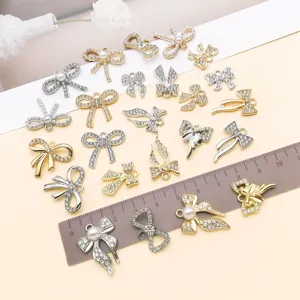 Detailed view of 24 styles bowknot rhinestone zinc alloy pendant charms for DIY jewelry making.