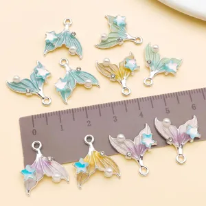 Detail view of 18x16mm gradient oil drip mermaid tail alloy charms with pearls and rhinestones.
