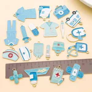 Close-up of blue medical enamel charms, assorted alloy stethoscope and pill pendants for DIY.