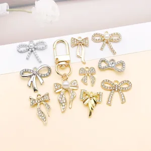 Close-up detail of alloy rhinestone bow charms, elegant hanging pendants for DIY jewelry.