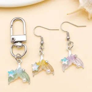 Detailed view of 18x16mm gradient enamel mermaid tail alloy charm with pearls and crystals.