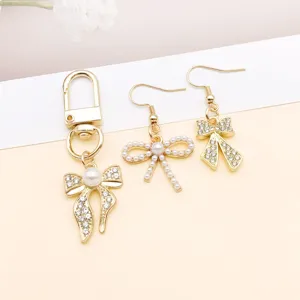Gold bow rhinestone pearl alloy pendant and earrings detail view for DIY jewelry making accessories