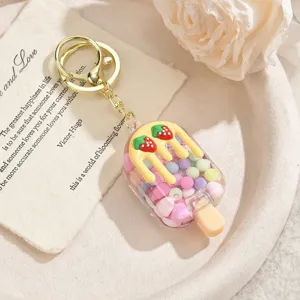 Cute strawberry ice cream keychain detail shot, showing clear liquid sand beads and gold ring.